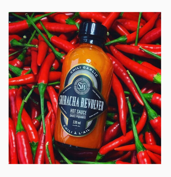 hot sauce bottle on chili peppers