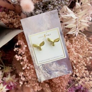 statement studs earring. gold eagles on card nestled in pink flowers