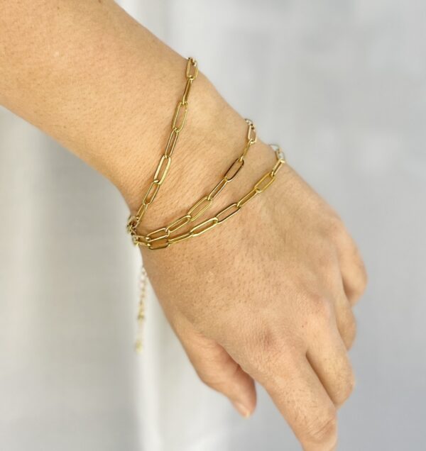 paperclip chain bracelets in gold on model