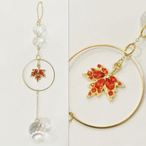 crystallized gold maple leaf pendant surrounded by metal hoop, gold chain, and glass beads